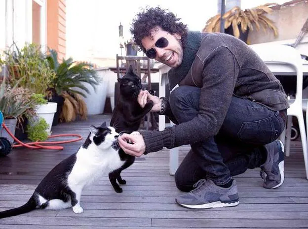 Juan Ibáñez posa con sus gatos, Tinta y Parulo./Carlos López.