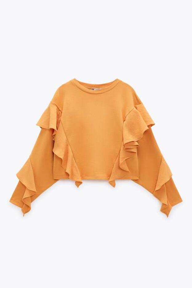 Si el diseño de esta sudadera corta con volantes ya es de lo más favorecedor, el color naranja le hace ganar puntos.