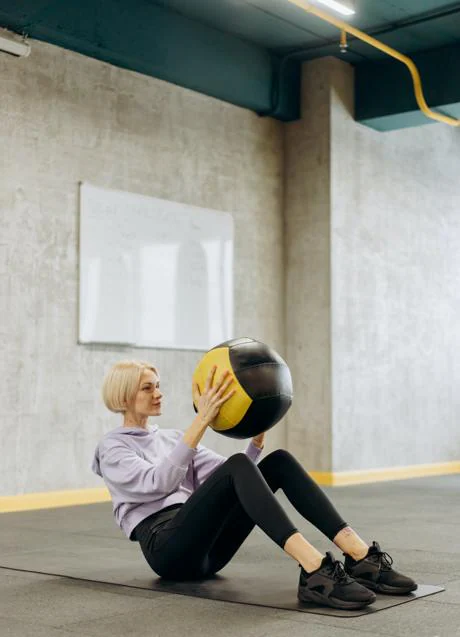 Woman exercising with ball/PEXELS