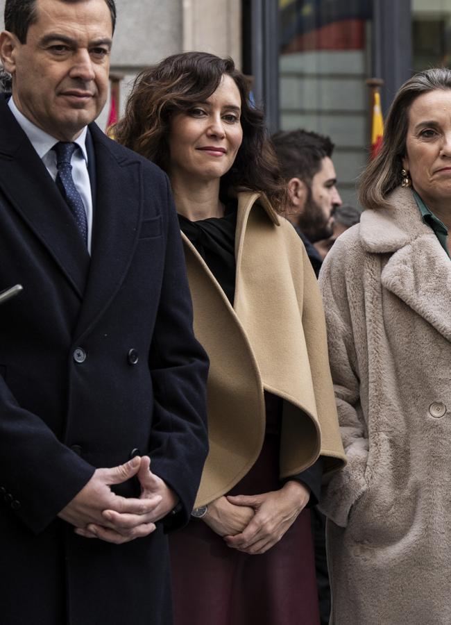 Isabel Díaz Ayuso con capa cortita y falda efecto piel burdeos.