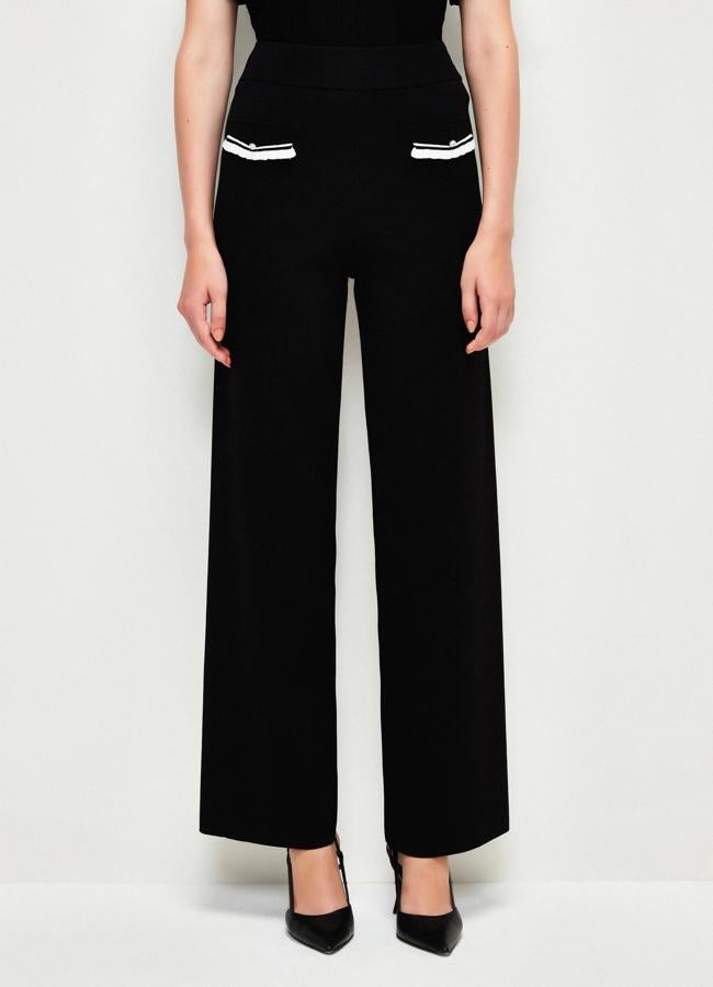 Pantalones negros de adL, 99,95 euros.