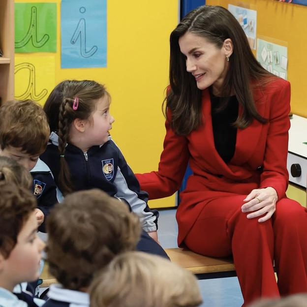 Letizia, en uan visita a un colegio, con su ya icónico traje rojo. 